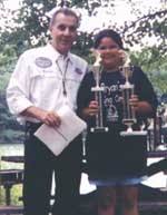 Ray Kerchal with Caroline Traino of Danbury, CT.  Caroline, in Group A, took first place in the Big Fish category with a bass of 1.79 pounds and second place in the Most Fish category with 58 fish - Friday, August 20, 1999