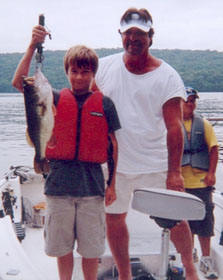 Max Schmitt of Newtown, CT with his 6.50 lb. bass (big fish of the week) and Boat Captain Scott Perratti  Tuesday, August 16, 2005