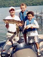 Zachary Cortese (8) and Antonio Rivera (8), both of Danbury, CT with boat captain Jess Caraballo and two 6 pound trout - August 15, 2001